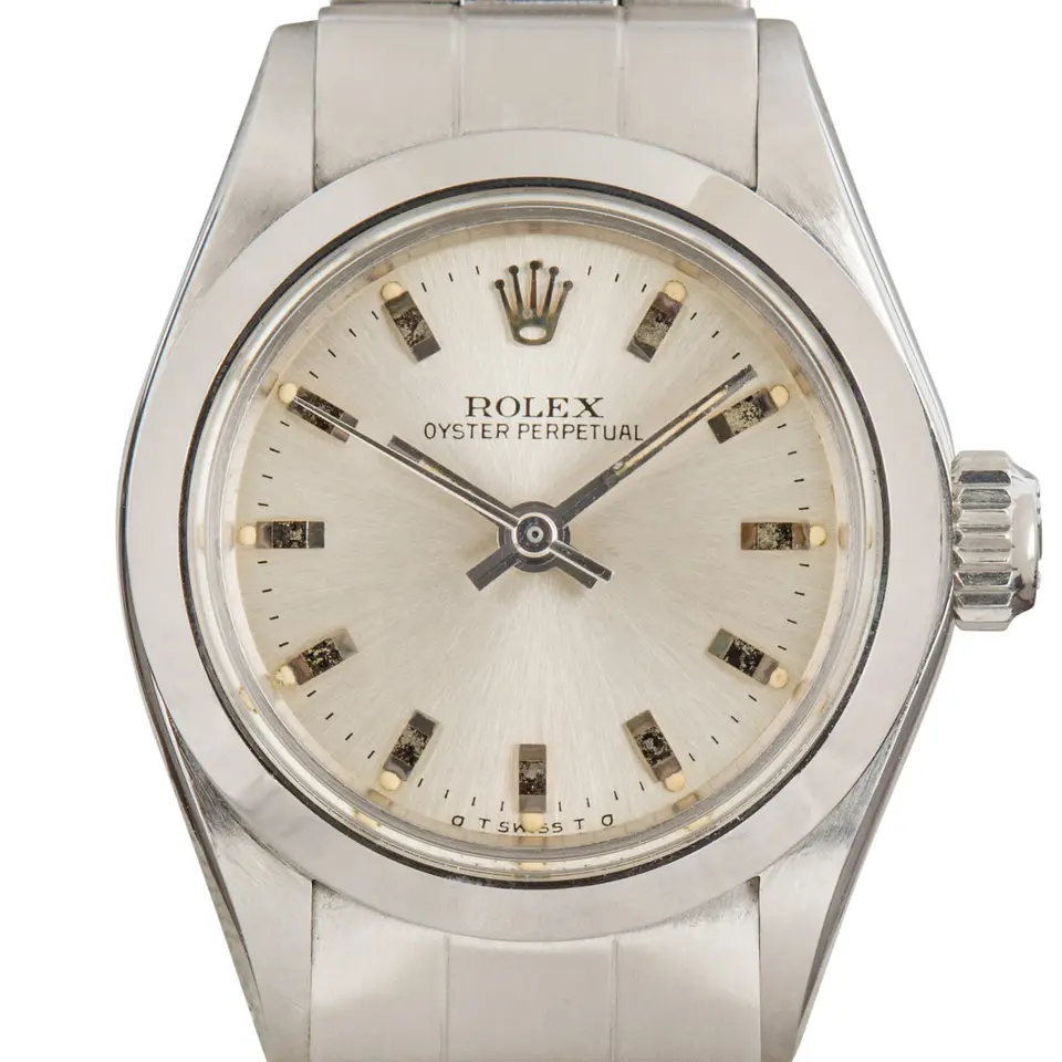 Rolex Oyster Perpetual 26 6718 with a silver dial, smooth steel bezel and steel Oyster bracelet, a pre-owned example, studio close-up of the case