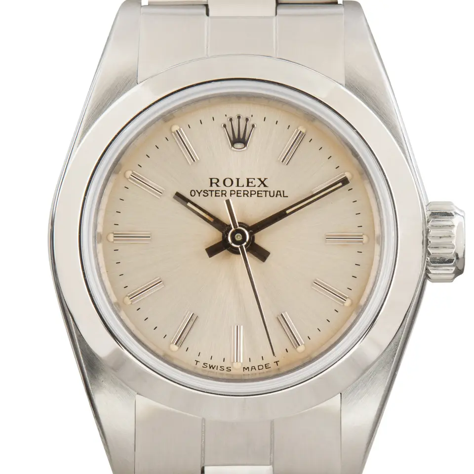 Rolex Ladies Oyster Perpetual 67180 with a silver dial, smooth steel bezel and steel Oyster bracelet, a pre-owned example, studio close-up of the case