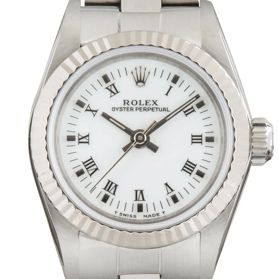 Rolex Ladies Oyster Perpetual 67194 with a white Roman-numeral dial, fluted white gold bezel and steel Oyster bracelet, a pre-owned example, studio close-up of the case