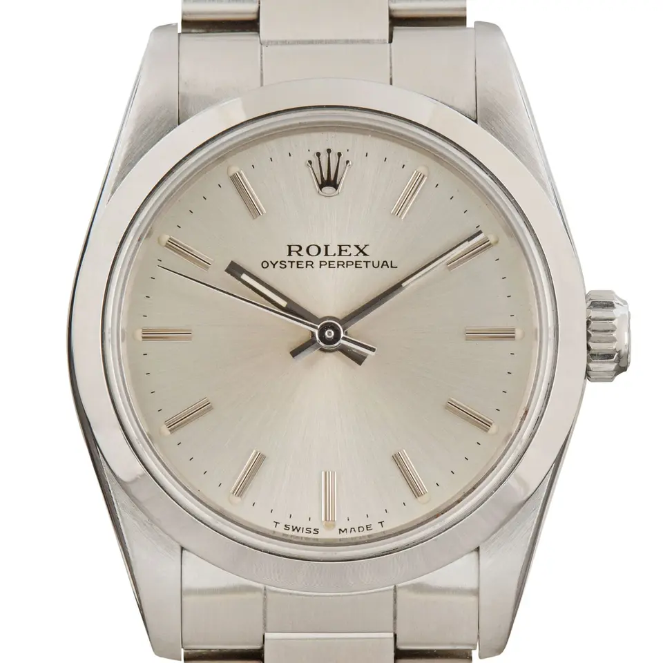 Rolex Oyster Perpetual 31 67480 with a silver dial, smooth steel bezel and steel Oyster bracelet, a pre-owned example, studio close-up of the case