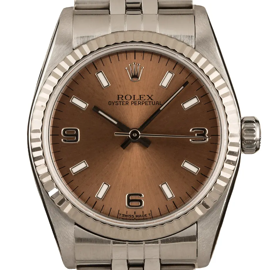 Rolex Oyster Perpetual 31 67514 with a brown dial with 3, 6 and 9 numerals, fluted white gold bezel and steel Jubilee bracelet, a pre-owned example, studio close-up of the case