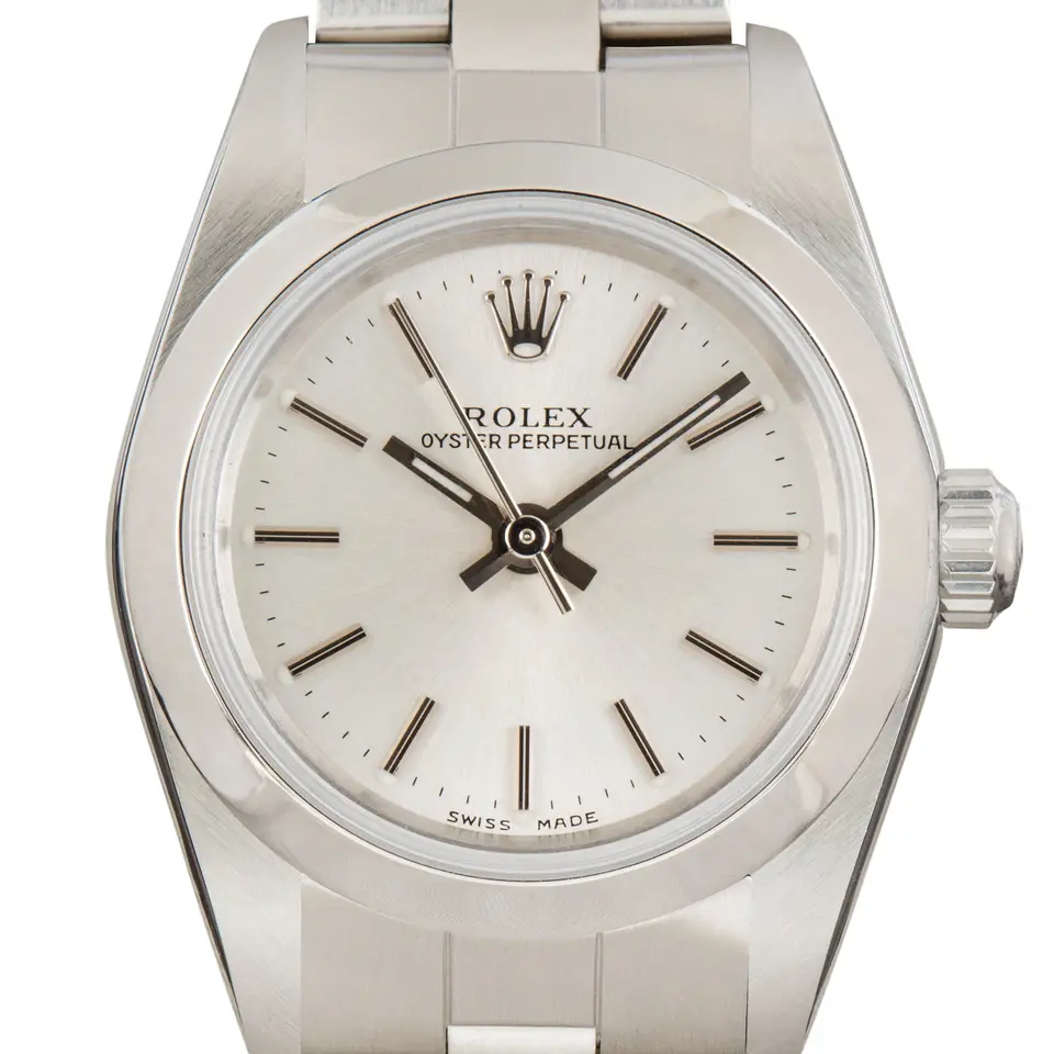 Rolex Ladies Oyster Perpetual 76080 with a silver dial, smooth steel bezel and steel Oyster bracelet, a pre-owned example, studio close-up of the case