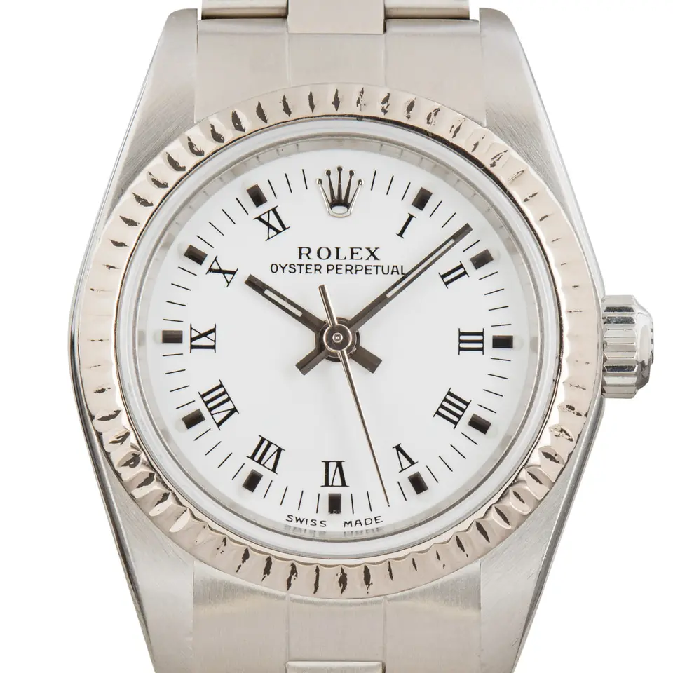 Rolex Oyster Perpetual 26 76094 with a white Roman-numeral dial, fluted white gold bezel and steel Oyster bracelet, a pre-owned example, studio close-up of the case
