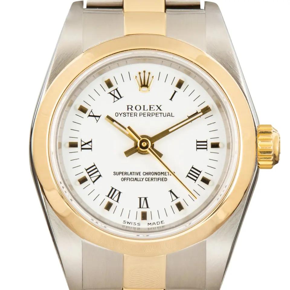 Rolex Oyster Perpetual 24 76183 with a white Roman-numeral dial, smooth yellow gold bezel and steel and gold Oyster bracelet, a pre-owned example, studio close-up of the case