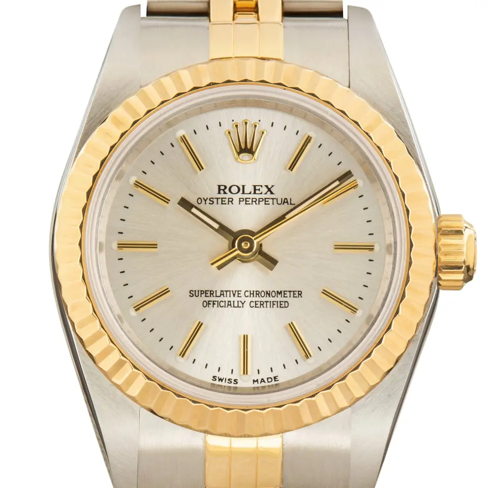 Rolex Oyster Perpetual 26 76193 with a silver dial, fluted yellow gold bezel and steel and gold Jubilee bracelet, a pre-owned example, studio close-up of the case