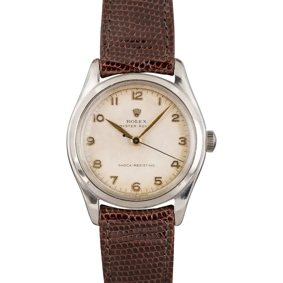 Rolex Oyster Royal 6144 with a cream Arabic-numeral dial, smooth steel case on a brown leather strap, a pre-owned example, front view of the whole watch