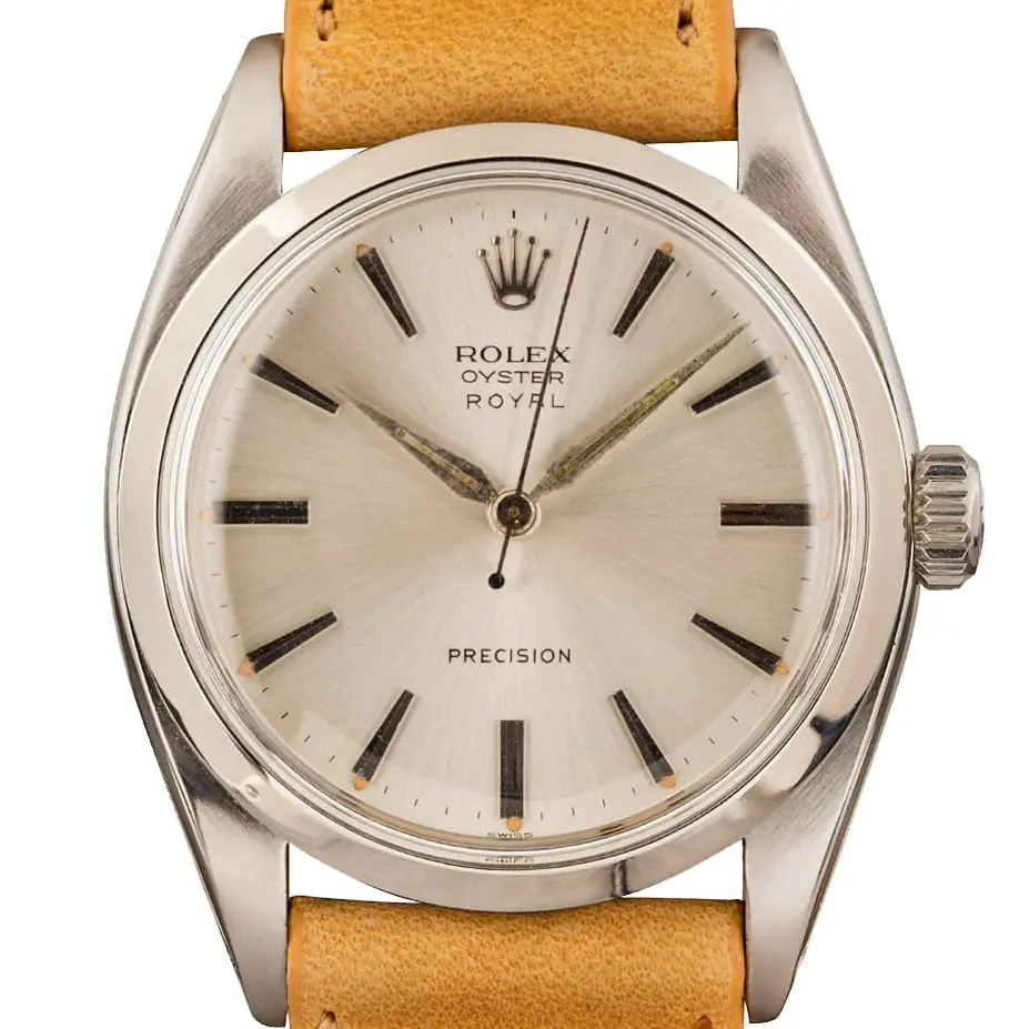 Rolex Oyster Precision 6422 with a silver Precision dial, smooth steel case on a tan leather strap, a pre-owned example, studio close-up of the case