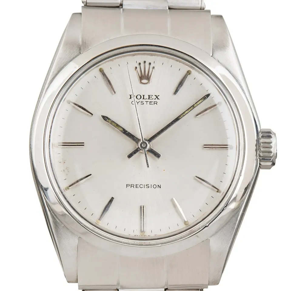 Rolex Oyster Precision 6426 with a silver Precision dial, smooth steel bezel and steel Oyster bracelet, a pre-owned example, studio close-up of the case