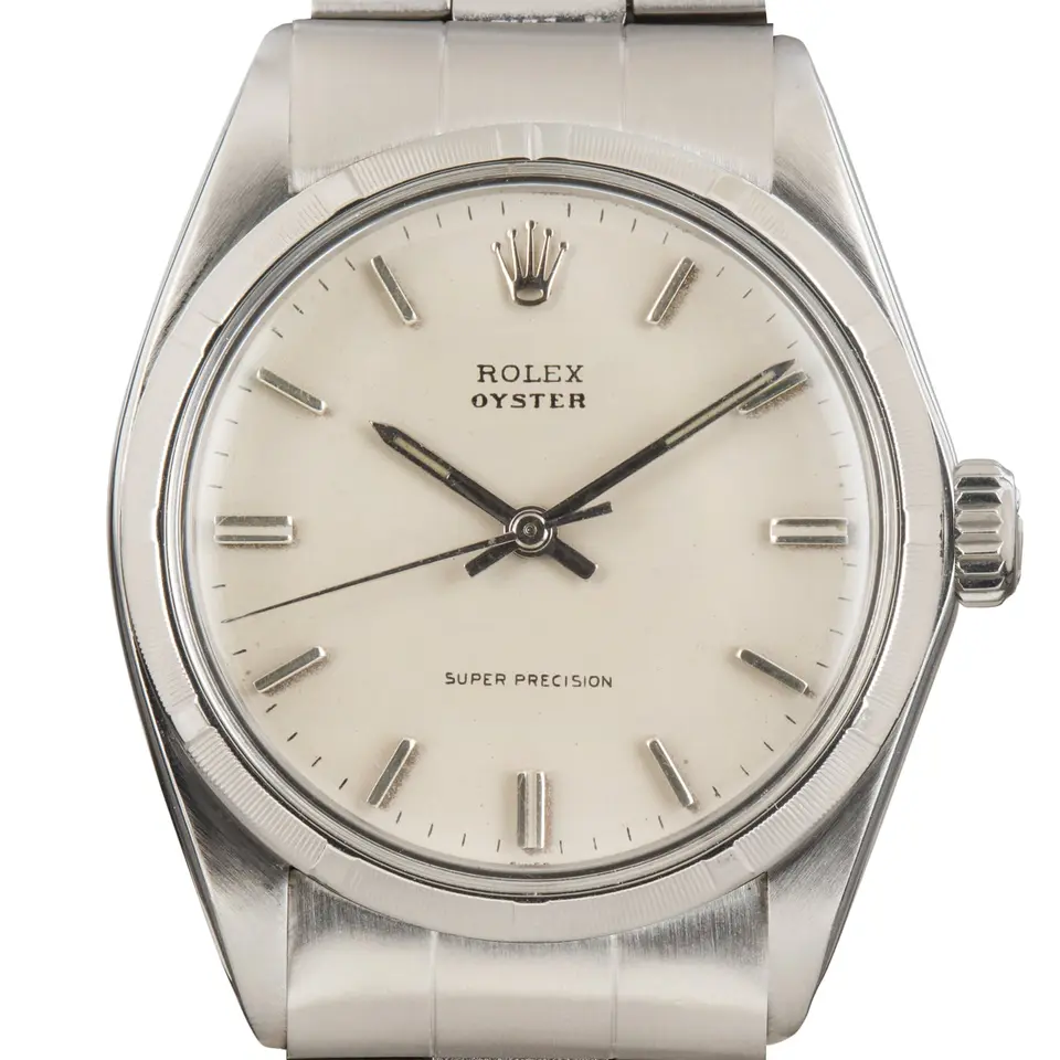 Rolex Oyster Precision 6427 with a silver Super Precision dial, smooth steel bezel and steel Oyster bracelet, a pre-owned example, studio close-up of the case