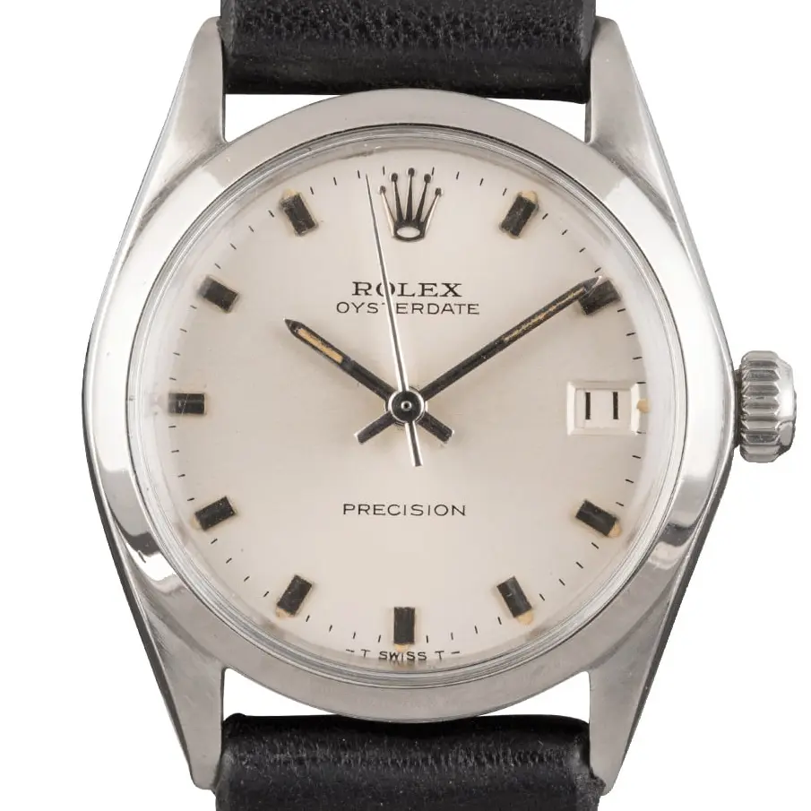 Rolex Oysterdate Precision 6466 with a silver OysterDate Precision dial, smooth steel case on a black leather strap, a pre-owned example, studio close-up of the case