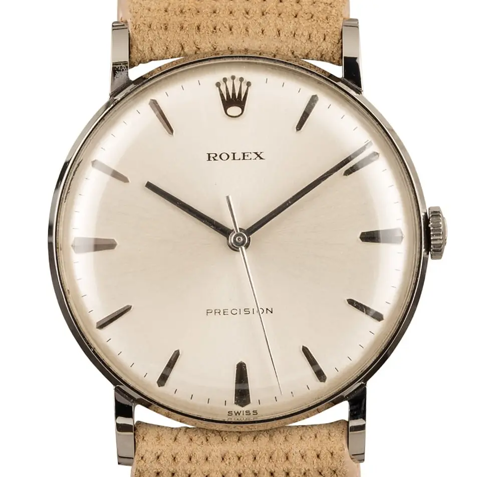 Rolex Precision 9829 with a silver Precision dial, round steel case on a beige leather strap, a pre-owned example, studio close-up of the case