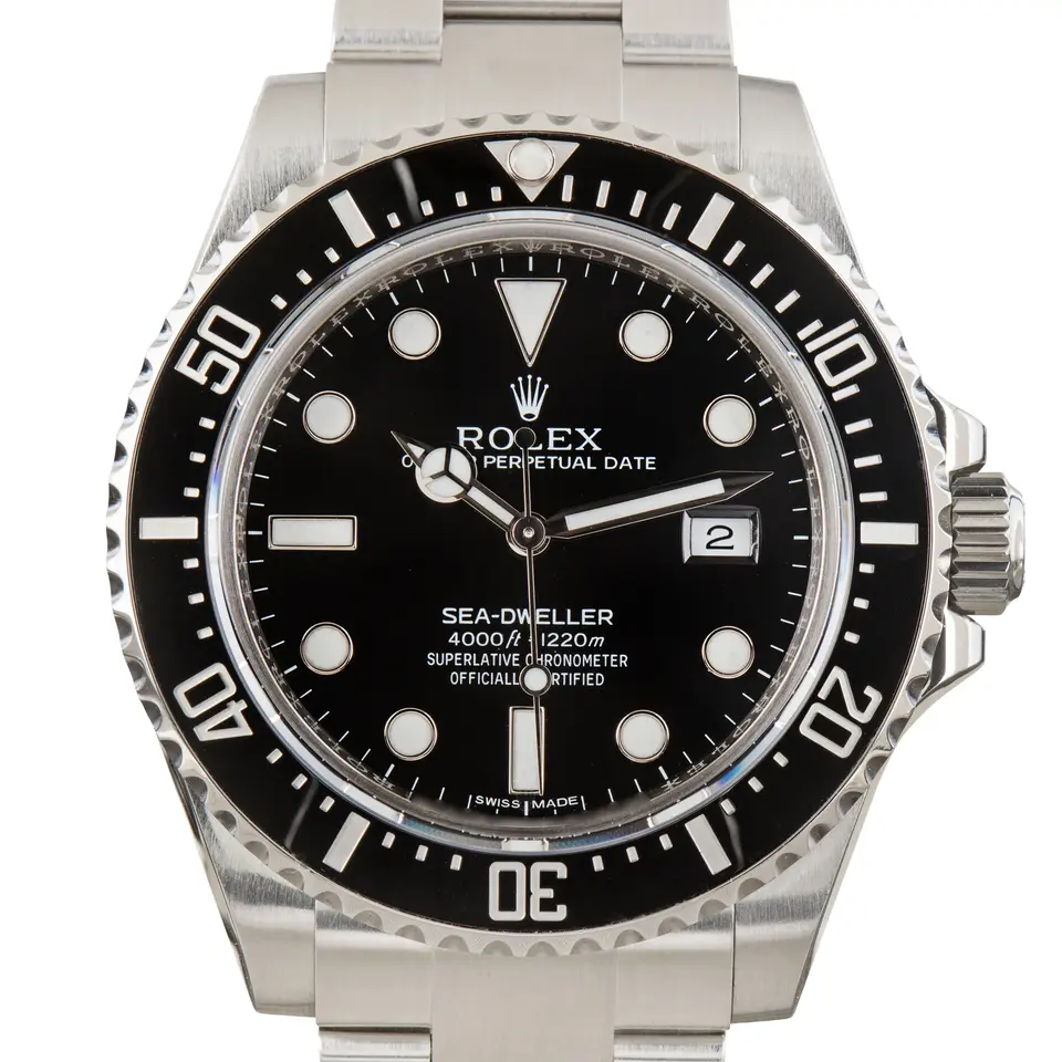 Rolex Sea-Dweller 4000 116600 with a black dial and black ceramic bezel on a steel Oyster bracelet, a pre-owned example, studio close-up of the case