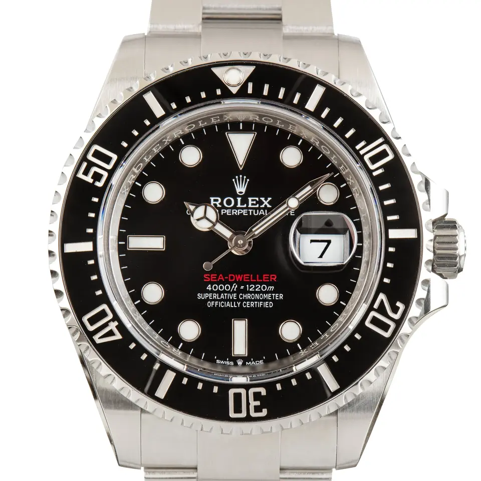 Rolex Sea-Dweller 126600 with a black dial with a red Sea-Dweller line and a black ceramic diving bezel, a pre-owned example, studio close-up of the case