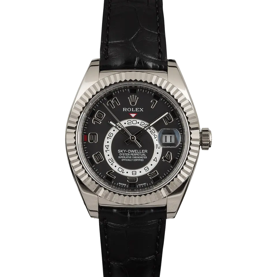 Rolex Sky-Dweller 326139 with a black dial with Arabic numerals and fluted white gold bezel on a black leather strap, a pre-owned example, front view of the whole watch