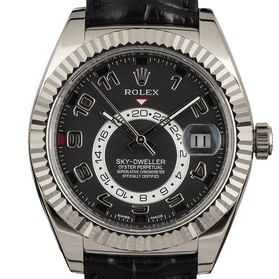 Rolex Sky-Dweller 326139 with a black dial with Arabic numerals and fluted white gold bezel on a black leather strap, a pre-owned example, studio close-up of the case