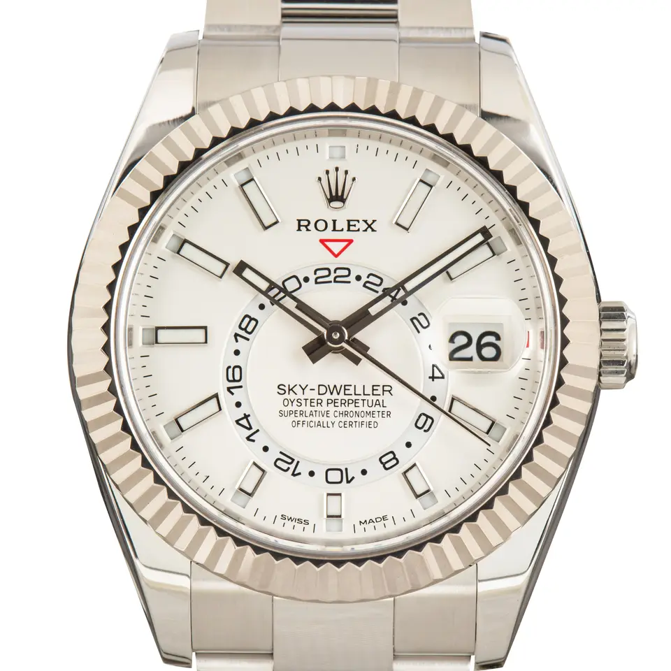 Rolex Sky-Dweller 326934 with a white dial and fluted white gold bezel on a steel Oyster bracelet, a pre-owned example, studio close-up of the case