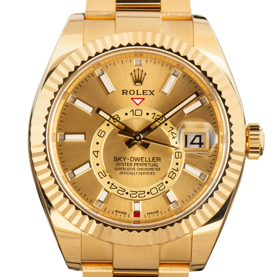 Rolex Sky-Dweller 326938 with a champagne dial and fluted yellow gold bezel in yellow gold on an Oyster bracelet, a pre-owned example, studio close-up of the case