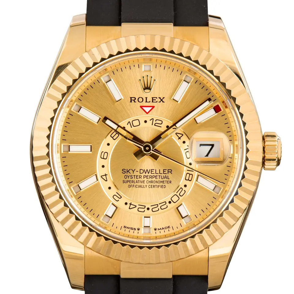 Rolex Sky-Dweller 336238 with a golden dial and a fluted yellow gold bezel, a pre-owned example, studio close-up of the case