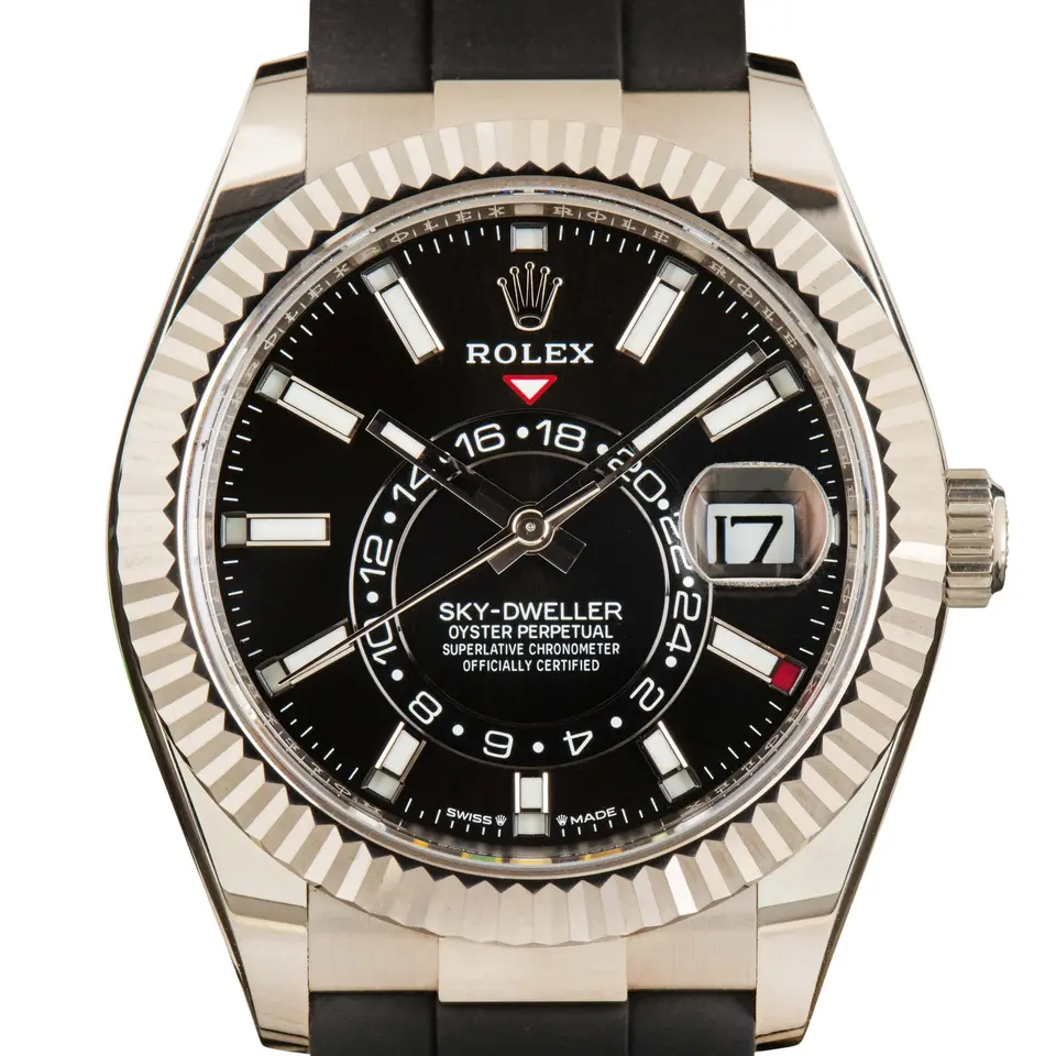 Rolex Sky-Dweller 336239 with a black dial and a fluted white gold bezel, a pre-owned example, studio close-up of the case
