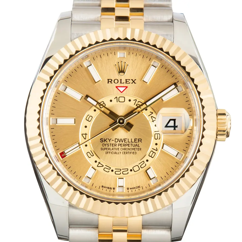 Rolex Sky-Dweller 336933 with a golden dial and a fluted yellow gold bezel, a pre-owned example, studio close-up of the case