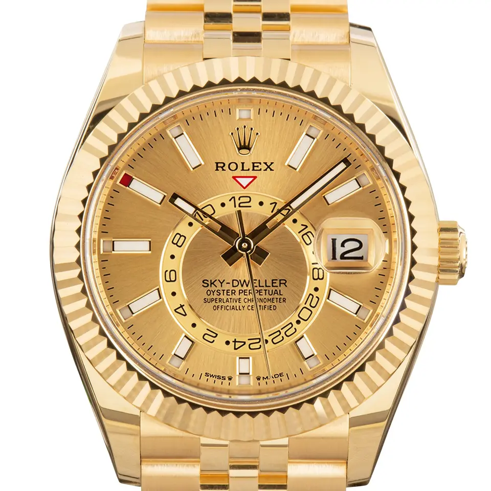 Rolex Sky-Dweller 336938 with a golden dial and a fluted yellow gold bezel, a pre-owned example, studio close-up of the case