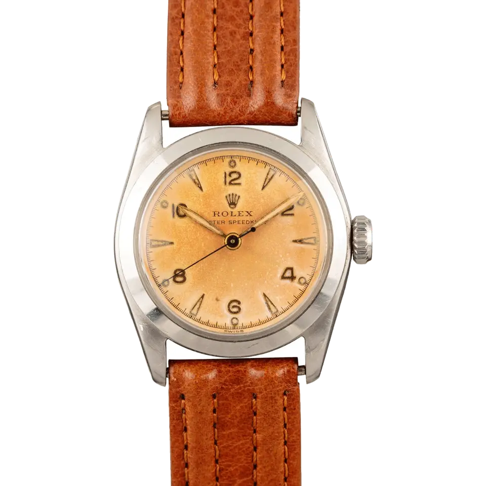 Rolex Speedking 6056 with a salmon Arabic-numeral dial, smooth steel case on a brown leather strap, a pre-owned example, front view of the whole watch