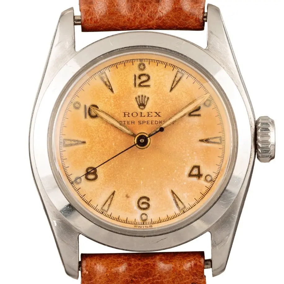 Rolex Speedking 6056 with a salmon Arabic-numeral dial, smooth steel case on a brown leather strap, a pre-owned example, studio close-up of the case
