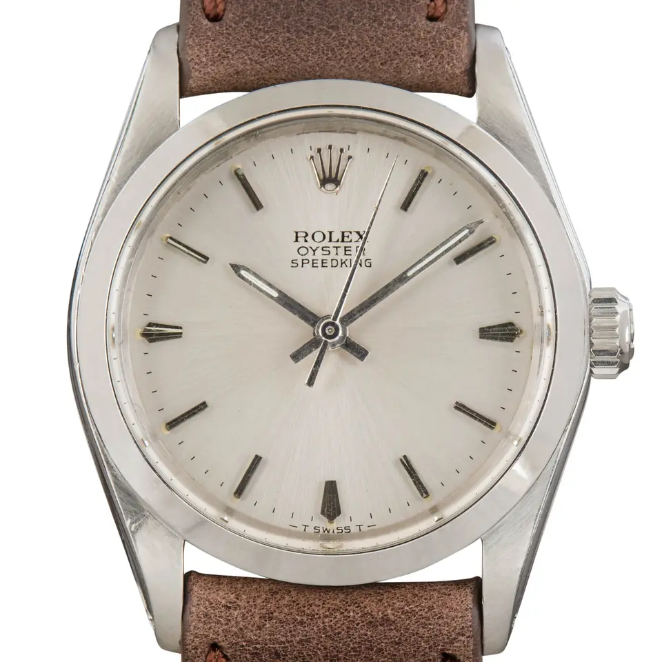 Rolex Oyster Speedking Precision 6430 with a silver dial, smooth steel case on a brown leather strap, a pre-owned example, studio close-up of the case