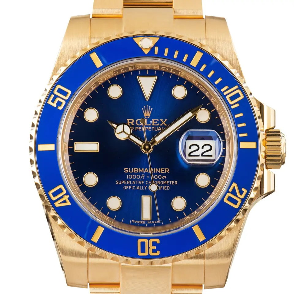 Rolex Submariner Date 116618LB with a blue dial and blue ceramic bezel in yellow gold on an Oyster bracelet, a pre-owned example, studio close-up of the case