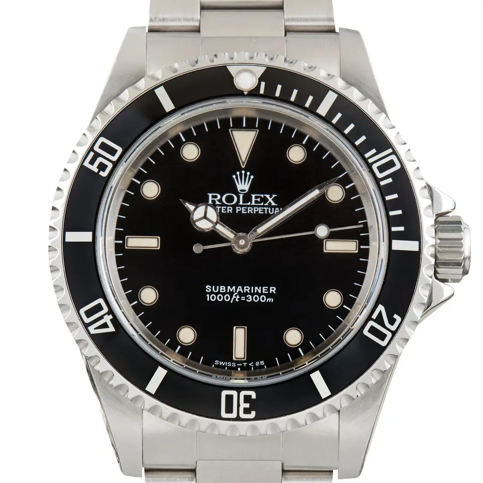 Rolex Submariner 14060 with a black dial without date and black aluminium bezel insert on a steel Oyster bracelet, a pre-owned example, studio close-up of the case