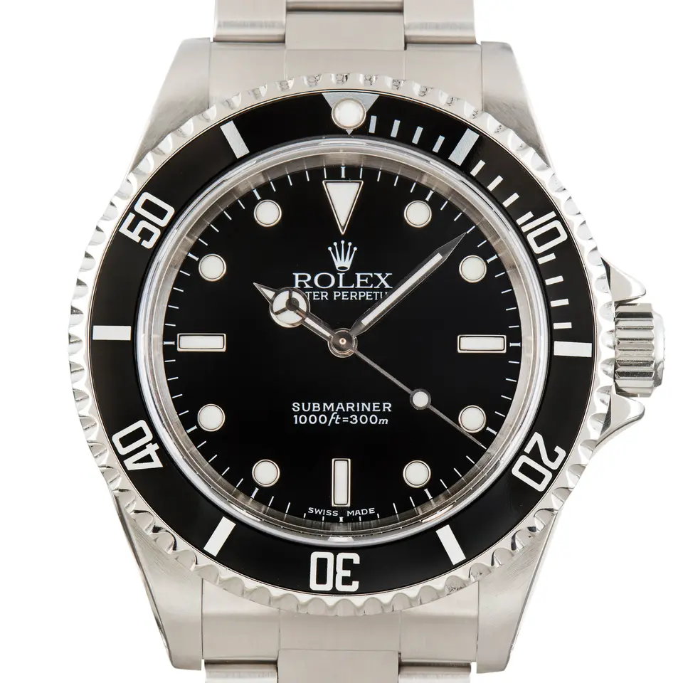 Rolex Submariner 14060M with a black dial without date and black aluminium bezel insert on a steel Oyster bracelet, a pre-owned example, studio close-up of the case