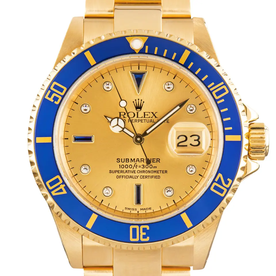 Rolex Submariner Date 16618 with a champagne dial with gem-set markers and blue bezel in yellow gold on an Oyster bracelet, a pre-owned example, studio close-up of the case