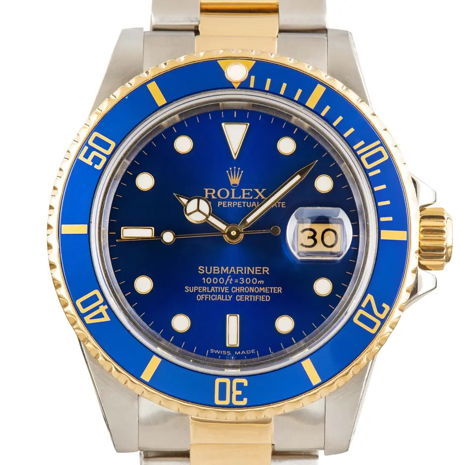 Rolex Submariner Date 16803 with a blue dial and blue bezel insert in steel and yellow gold on an Oyster bracelet, a pre-owned example, studio close-up of the case