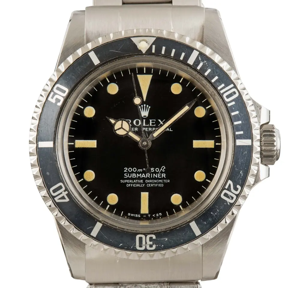 Rolex Submariner 5512 with a black dial and black bezel insert with crown guards on a steel Oyster bracelet, a pre-owned example, studio close-up of the case
