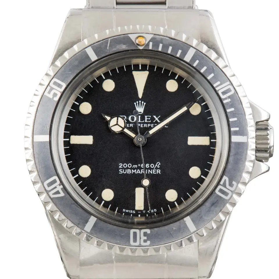 Rolex Submariner 5513 with a black dial and faded black bezel insert on a steel Oyster bracelet, a pre-owned example, studio close-up of the case