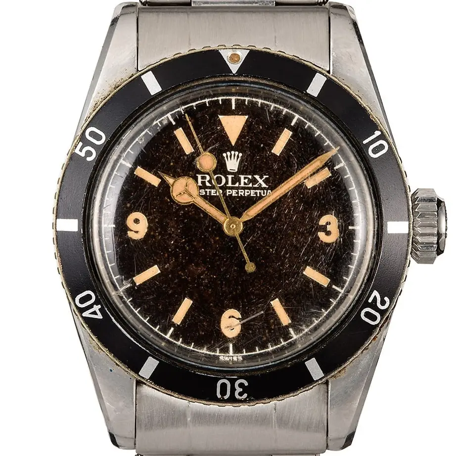 Rolex Submariner 6200 with a brown-aged (tropical) gilt dial with 3, 6 and 9 numerals and black bezel on a steel bracelet, a pre-owned example, studio close-up of the case