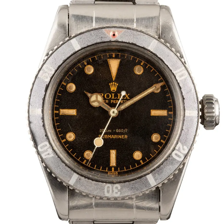 Rolex Submariner 6538 with a brown-aged (tropical) gilt dial and faded bezel insert on a steel bracelet, a pre-owned example, studio close-up of the case