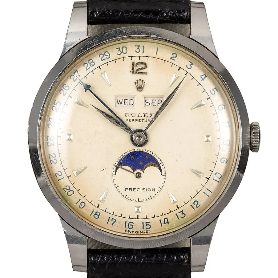 Rolex Triple Calendar Moonphase 8171 with a cream triple-calendar dial with moon phase and pointer date, steel case on a black leather strap, a pre-owned example, studio close-up of the case