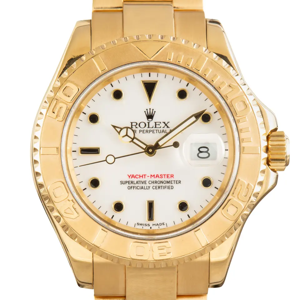 Rolex Yacht-Master 16628 with a white dial and raised yellow gold bezel in yellow gold on an Oyster bracelet, a pre-owned example, studio close-up of the case