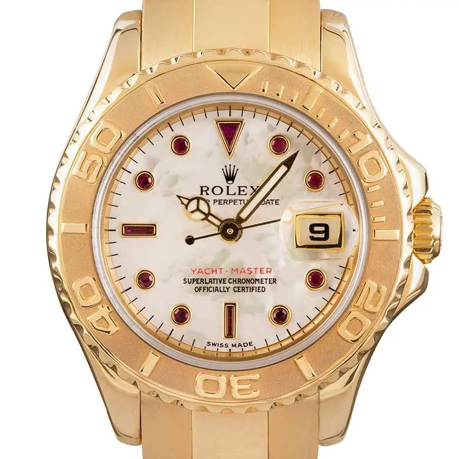Rolex Yacht-Master 169628 with a mother-of-pearl dial with ruby markers, yellow gold rotating bezel and yellow gold Oyster bracelet, a pre-owned example, studio close-up of the case