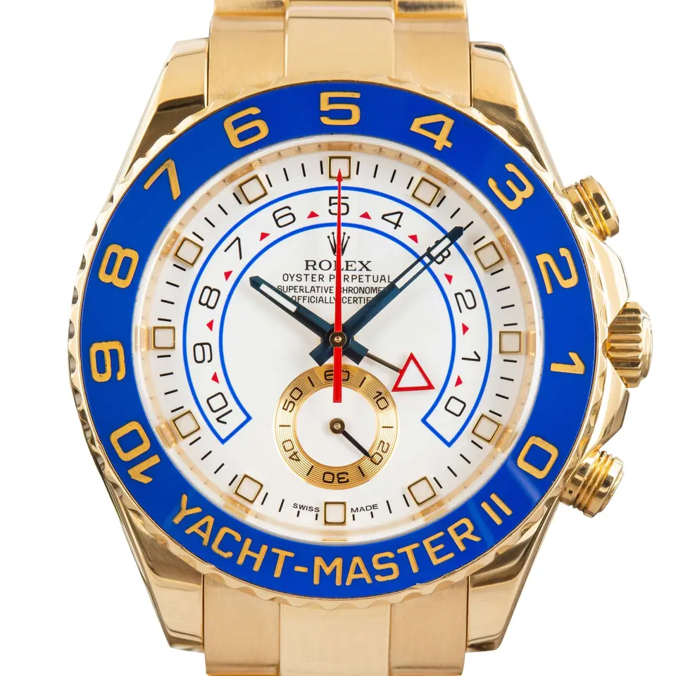 Rolex Yacht-Master II 116688 with a white dial, blue ceramic regatta bezel and red countdown hand in yellow gold on an Oyster bracelet, a pre-owned example, studio close-up of the case