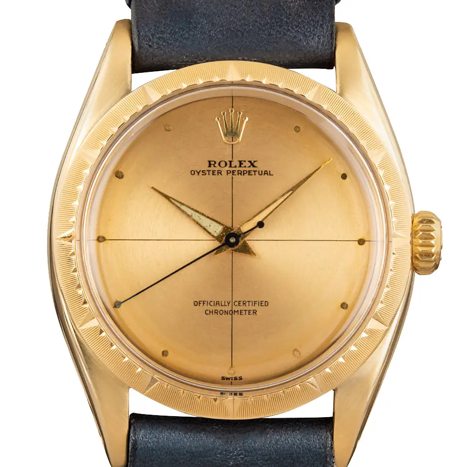 Rolex Zephyr 6582 with a gold dial with cross-hair lines, engine-turned yellow gold bezel and gold case on a navy leather strap, a pre-owned example, studio close-up of the case